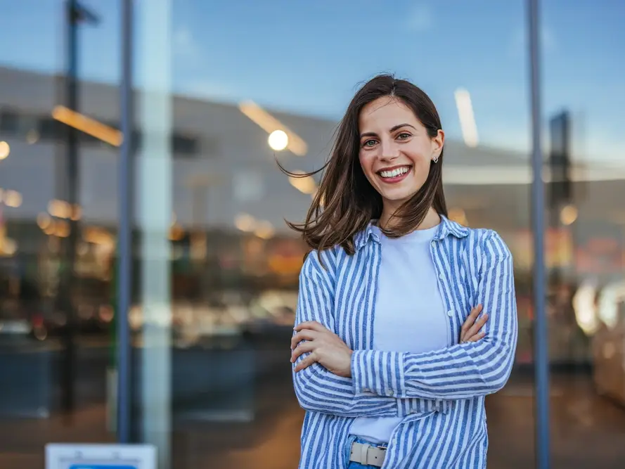 Confident young woman smiling brightly, representing Invisalign and Orthodontics in Ingram at West Kerr Dental