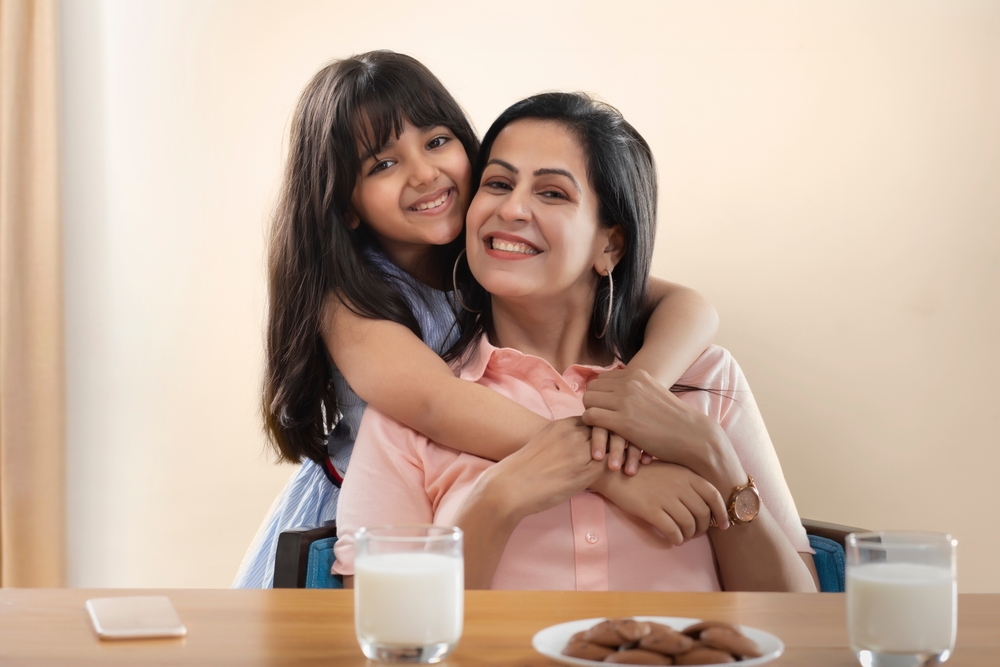 Happy mother and daughter smiling together, promoting Invisalign treatment at West Kerr Dental for families