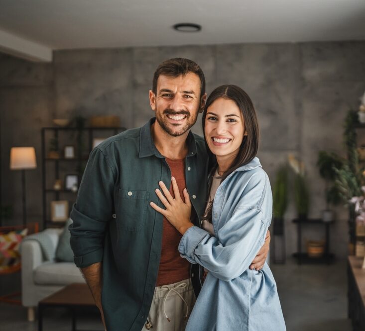 Smiling couple standing together indoors, representing confidence and healthy smiles with Dental Services at West Kerr Dental